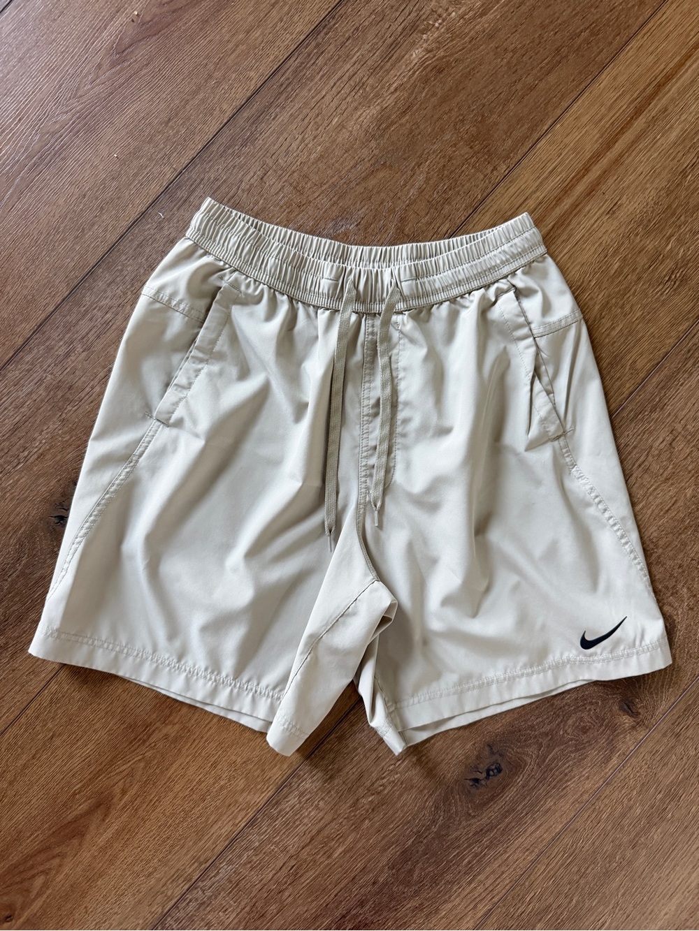 Nike Beige Athletic Shorts with Black Swoosh